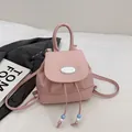 Pink faux leather mini backpack with drawstring closure and oval metal hardware logo - Pink