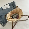 Beige hollow knit tote bag with brown faux leather handles and daily essentials inside - Beige (With Lining)
