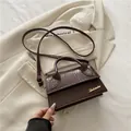 Elegant dark brown crocodile pattern crossbody bag with golden logo and top handle - Brown