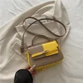 Chic color-block saddle handbag in yellow and grey leather with adjustable strap - Yellow