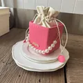 Pink woven bucket bag with pearl handle and drawstring lining for summer fashion style - Pink