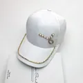 Close-up of white jacquard baseball cap with pearl heart and rhinestone chain details - Adult Size, 58cm Adjustable Circumference / White