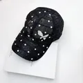 Detailed view of black lace baseball cap with sparkling rhinestones and butterfly badge - One Size / Black