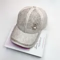 Detailed macro view of beige floral lace baseball cap with rhinestone bear and pearls - Adult, Adjustable / Beige