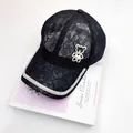 Detail of lace floral baseball cap featuring rhinestone bear with heart pearl accent - Adult, Adjustable / Black