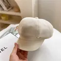 Chic beige wool octagonal newsboy hat with a leather brim and gold metal accent detail - M / Beige