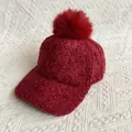 Detailed macro shot of deep red faux fur pom-pom on textured lamb wool winter baseball cap - L (56-60cm) / Burgundy