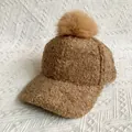 Detailed close-up of brown faux fur pompom and plush lamb wool texture on a winter baseball cap - L (56-60cm) / Khaki