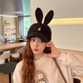 Close-up of black fuzzy bunny ear baseball cap with rabbit embroidery and plush texture - Black