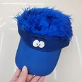 Detail view of the embroidered cartoon eyes and blue synthetic wig hair on the baseball cap - Blue Funny Large Eyes Style / Sapphire Blue