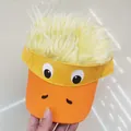 Detail of funny duck baseball cap with yellow faux fur wig and embroidered eyes - Funny Duck Style / Orange Yellow