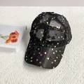 Close-up of black mesh baseball cap with sequin plum blossom and iridescent accents - Adult Size (Adjustable) / Black