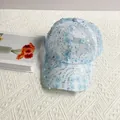 Detailed close-up of light blue mesh baseball cap with 3D floral petals and sequins - Adult Size (Adjustable) / Blue