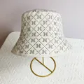 Detail of white bucket hat with silver rhinestone lattice pattern and N logo letter - M (56-58cm) / White