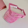 Detail of pink visor cap with sparkling rhinestones, M logo, and adjustable velcro strap - Pink