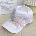 Detail of white satin baseball cap featuring colorful 3D floral embroidery and rhinestones - Adult Size (Adjustable) / White Rhinestone Flower