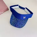 Close-up of sparkling blue rhinestones and silver M logo on a navy sun visor hat - Sapphire Blue
