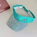 Detail of turquoise sun visor with iridescent rhinestones and silver M metal logo - Lake Green