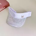 Close-up of light purple sun visor with crystal-encrusted brim and silver M logo - White