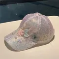 Detail view of 3D lace flowers and iridescent sequins on a white mesh baseball cap - Pink Butterfly Flowers
