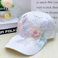 Detailed view of floral embroidery and pearls on white silk-like sun baseball cap - Adult Size (Adjustable) / White Lace Pearl Flower