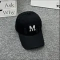 Detailed view of black baseball cap with rhinestone M letter and distressed torn accents - Adult One Size (Adjustable) / Black