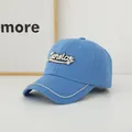 Close-up of sky blue baseball cap with Sunday embroidery and sparkling rhinestone trim - Adult Size (Adjustable) / Sapphire Blue