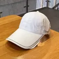 White quick-dry baseball cap with extended brim and side embroidery on wood table - White