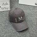 Close-up of distressed denim baseball cap with rhinestone M letter and frayed details - Adult One Size (Adjustable) / Gray
