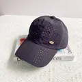 Detail of laser-cut perforated vents and gold oval logo on quick-dry baseball cap - Adult One Size (54-59cm) / Navy Blue