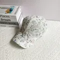 Detail of floral lace baseball cap with 3D iris embroidery and delicate pearl accents - Adult Size (Adjustable) / Light Purple