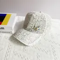 Detail of white lace baseball cap featuring sparkling rhinestones and metal butterfly charm - Adult Size (Adjustable) / White