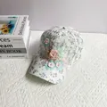 Close-up of handmade 3D floral appliques and white faux pearls on sweet lace baseball cap - Adult, Adjustable / Purple