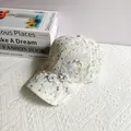 Detail of white lace baseball cap with floral print, 3D embroidery and pearl accents - Adult Size (Adjustable) / Light Blue
