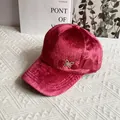 Close-up of pink velvet baseball cap with a sparkling gold butterfly pendant detail - Adult Size (Adjustable) / Burgundy