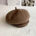 Detailed macro view of dark brown wool beret with small silver rivets on the rim - L (54-60cm) / Mocha