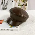Detail of soft dark brown PU leather newsboy cap with vintage stitching and texture - M / Coffee