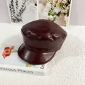 Detail of burgundy PU leather newsboy hat with textured finish and stitched crown design - M / Burgundy