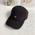 Close-up of black fleece baseball cap featuring a golden H letter buckle decoration - Adult Adjustable / Black