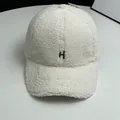 Close-up of white fleece baseball cap with black embroidered H letter and soft texture - Adult Adjustable / White