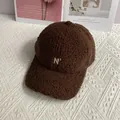 Close-up of the plush teddy fleece texture and N degree letter embroidery on dark brown cap - Adult Size (Adjustable) / Coffee