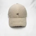 Detailed close-up of the beige sherpa baseball cap featuring a brown embroidered H letter - Adult Size (Adjustable) / Beige