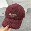 Detailed close-up of burgundy teddy fleece baseball cap with cream letter embroidery - Adult Size (Adjustable) / Burgundy