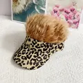 Close-up of leopard print visor cap featuring light brown synthetic wig hair on top - Adult, Adjustable / Light Brown Wig Hair