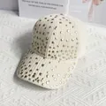 Detailed close-up of cream striped corduroy baseball cap with golden rivets decoration - L / Off White