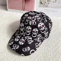 Close-up of skull printed baseball cap with red eye details on fabric background - Adult Size (Adjustable) / Black