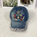 Detailed view of colorful rhinestone crown embellishment on dark blue denim baseball cap - Adult Adjustable / Dark Blue Crown Style 1
