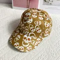 Detail of mustard yellow baseball cap with dense white and red skull prints - Adult Size (Adjustable) / Khaki