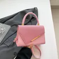 Chic light pink trapezoid handbag in textured tweed and smooth leather with gold hardware - Pink