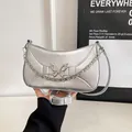 Silver crescent underarm bag with metallic finish and decorative butterfly buckle - Silver